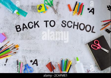 Back to school text with office supplies on white board. Stock Photo