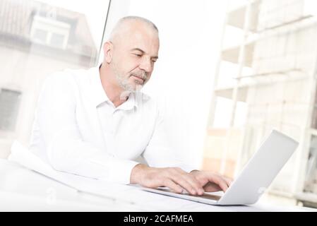 Closeup shot of an old male working on his office Stock Photo