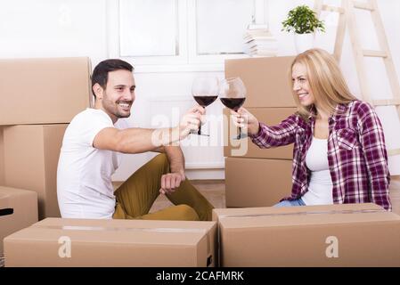 Happy young couple celebrating moving into a new apartment Stock Photo