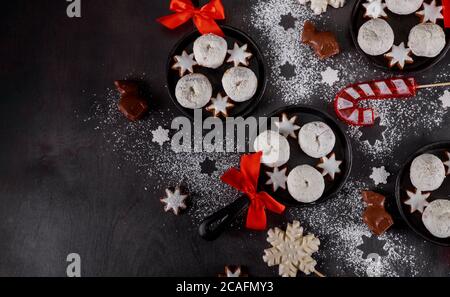 Christmas pan with tasty mini sugar powdered donuts on dark background. Stock Photo