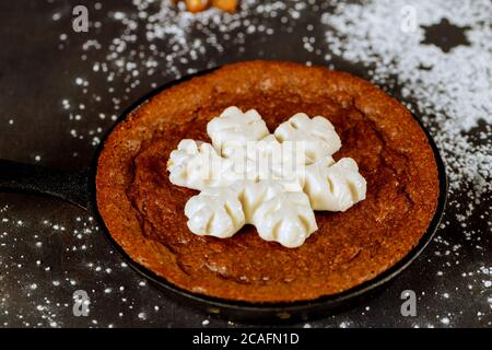Chocolate brownie with snowflake candy on the top in mini skillet. Stock Photo