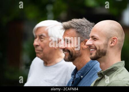 Three Generation Men Family Portraits Side View Stock Photo