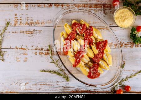 Stuffed shells pasta with parmesan, tomato sauce and ricotta cheese baked in oven pan. Stock Photo