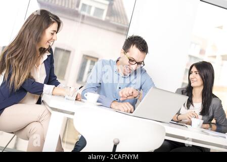 Group of successful businessmen discussing issues in modern office Stock Photo