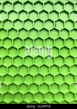 texture made of green plastic in the form of honeycombs close-up, abstract background Stock Photo