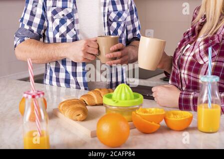 Lovely couple having breakfast in the kitchen Stock Photo