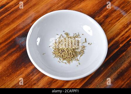 A teaspoon of organic thyme in a spice bowl Stock Photo