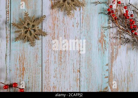 Christmas composition. Sparkle snowflakes and red frozen berries branches on wooden background. Winter, new year concept. Stock Photo