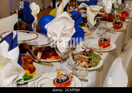Festive dinner table setting with meal in restaurant. Stock Photo