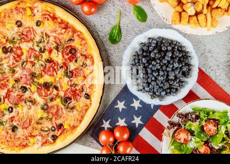 Veterans Day party table with delicious food and flag for american holiday. Stock Photo