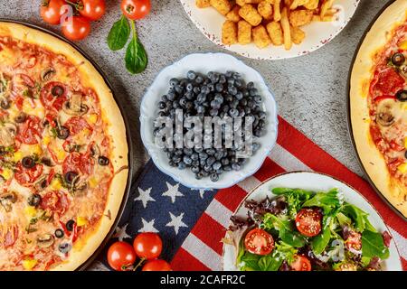 National party table with delicious food and flag for american holiday. Stock Photo