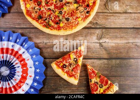 Pizza party for american holiday on rustic wooden table. Stock Photo