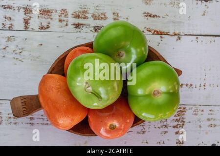 organic tomatoes and tomatillos on vintage table Stock Photo