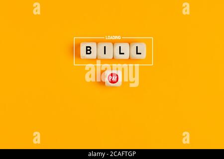 The word bill loading written on wood blocks with a push button with the word pay. Concept of online bill payment in business or finance. Stock Photo