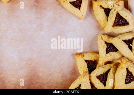 Purim background with cookies on old parchment paper. Stock Photo