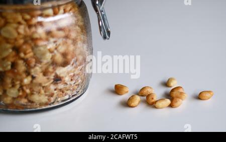 Fried peanuts in a jar on white background. Stock Photo