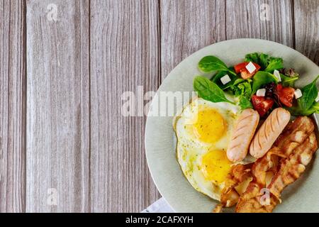 Dish with breakfast delicious meal on wooden background. Stock Photo
