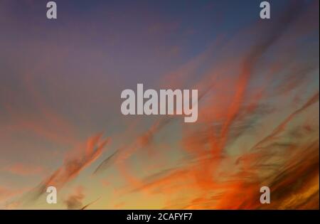 Beautiful colorful sunset sky with few clouds for wallpaper. Stock Photo