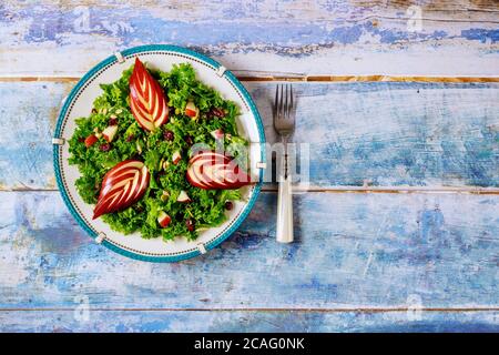Delicious salad with green kale, cranberry and red apple. Healthy food concept. Stock Photo