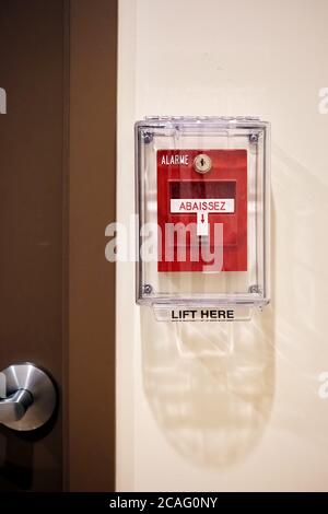 Fire alarm switch on th einterior wall of an office building next to the door. Stock Photo