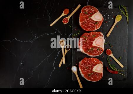 Three pieces of raw fresh beef shank bone in with spices and herb. Top view. Stock Photo