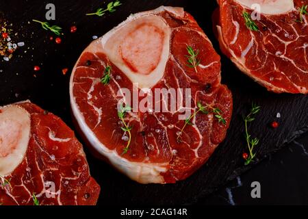 Three pieces of raw fresh beef shank bone in with spices and herb. Close up. Stock Photo