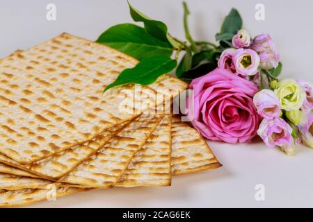 Matzah bread with pink roses. Jewish Passover holiday concept. Stock Photo