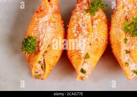 Three mega shells jumbo pasta on plate, stuffed with ricotta. Close up. Stock Photo