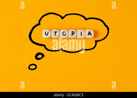 The word utopia written on wooden cubes framed with a thought bubble. Concept of thinking or dreaming of an utopia. Stock Photo
