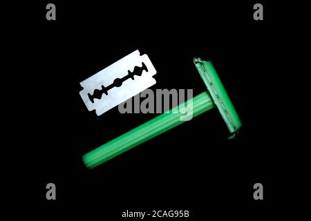 Plastic shaving razor with stainless steel blade on black backgrounds Stock Photo