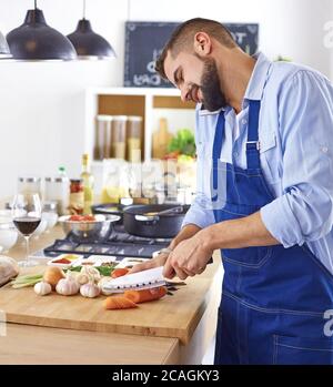 Young chef prepares a man in the kitchen Stock Photo