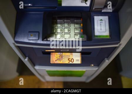 Euro banknote is ejected from the ATM. Stock Photo
