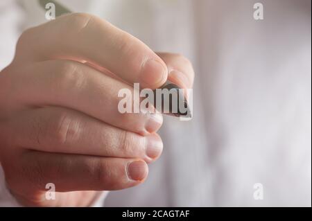 Virtual signature theme. Touch pen in man hand close up view Stock Photo
