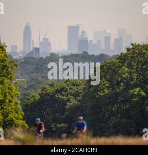 Richmond Park, London, UK. 7 August 2020. Skyscrapers of central London shimmer through a morning heat haze, seen from the green oasis of Richmond Park on a day when temperatures might break records. Credit: Malcolm Park/Alamy Live News. Stock Photo
