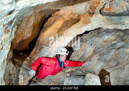 Caver exploring the cave Stock Photo