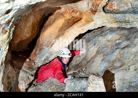 Caver exploring the cave Stock Photo