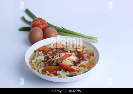 Mie Godog Jawa or Noodle soup is Javanese and Indonesian food with noodle ingredients and cabbage on plate. it tastes delicious. Stock Photo