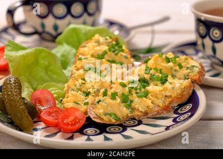 Sandwich with  scrambled eggs on the plate Stock Photo
