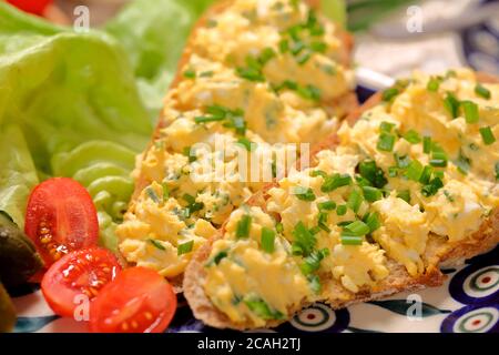 Sandwich with  scrambled eggs on the plate Stock Photo