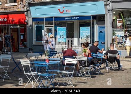 Tui holiday travel agent agents high street shop store in the city centre and outside cafe seating York North Yorkshire England UK GB Great Britain Stock Photo