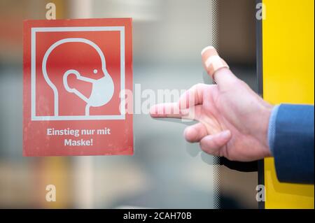 Stuttgart, Germany. 07th Aug, 2020. Winfried Hermann (Bündnis 90/Die Grünen), Minister of Transport of Baden-Württemberg, points to the notice 'boarding only with a mask' during a press event where the new information boards on the compulsory wearing of masks in trains and stations will be presented. Credit: Sebastian Gollnow/dpa/Alamy Live News Stock Photo