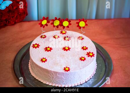 Big cake decorated with berries and flowers with a first birthday Stock Photo