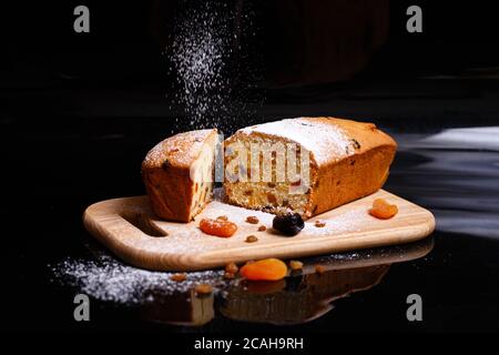 Sweet cupcake in the shape of bread. Cupcake with raisins, dried apricots, plums. Stock Photo