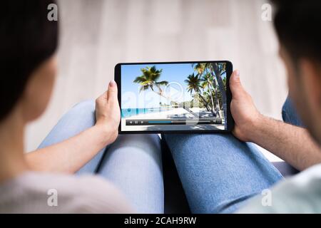 Young People Watching Streaming Videos On Tablet Stock Photo