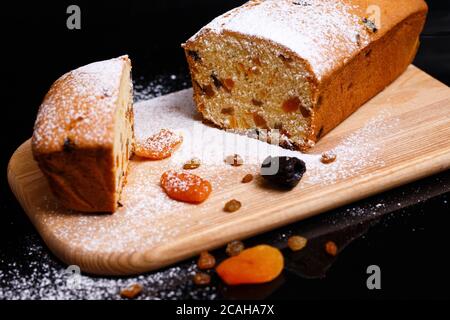 Sweet cupcake in the shape of bread. Cupcake with raisins, dried apricots, plums. Stock Photo