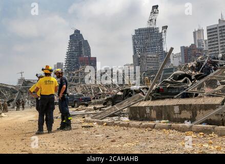 Beirut, Lebanon. 07th Aug, 2020. German civil defence members stand among huge destruction inside Beirut port, as several defence workers from foreign countries joined their Lebanese colleagues in search for victims of the massive explosion at Beirut port on Tuesday. Credit: Marwan Naamani/dpa/Alamy Live News Stock Photo