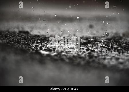 Rain water drops on rain water. heavy rain falling and water splashing useful background. Stock Photo