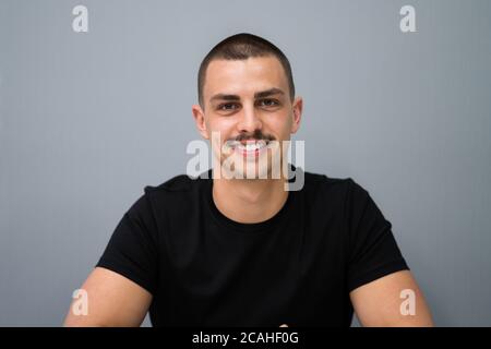 Smiling Young Man Portrait At Workplace In Office Stock Photo