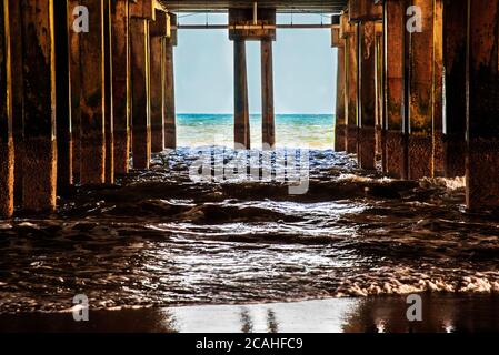 Waves break against wooden pier pillars on Atlantic City Beach. New Jersey. Stock Photo