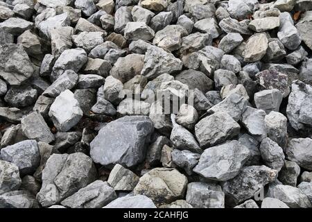pile of odd shaped natural stone block boulders rocks with shadows detailed contour shades suitable for website background marketing backgrounds Stock Photo